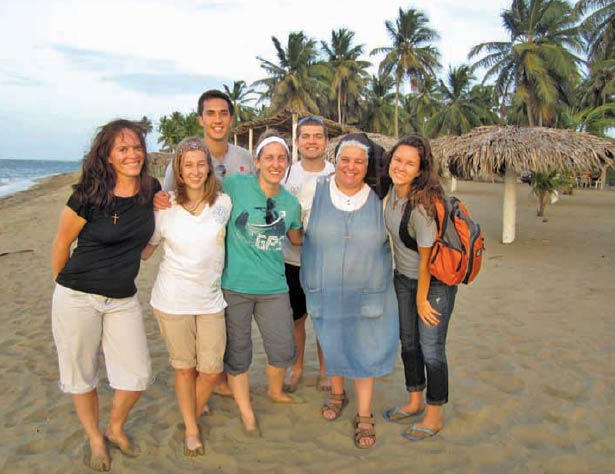 Missionary of the Most Sacred Heart of Jesus (MSC) Sister Lisa Valentini gathers on the beach in the Dominican Republic with college students and adults who joined her for Mission Experience. (Photo courtesy MSCs of Reading)